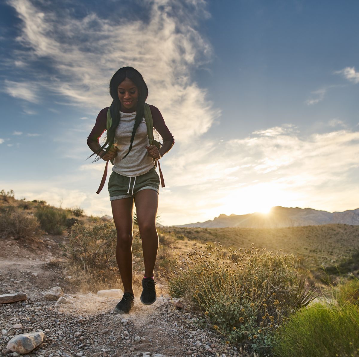 Image of a Woman on Hiking Tours with the Sunset in the Background